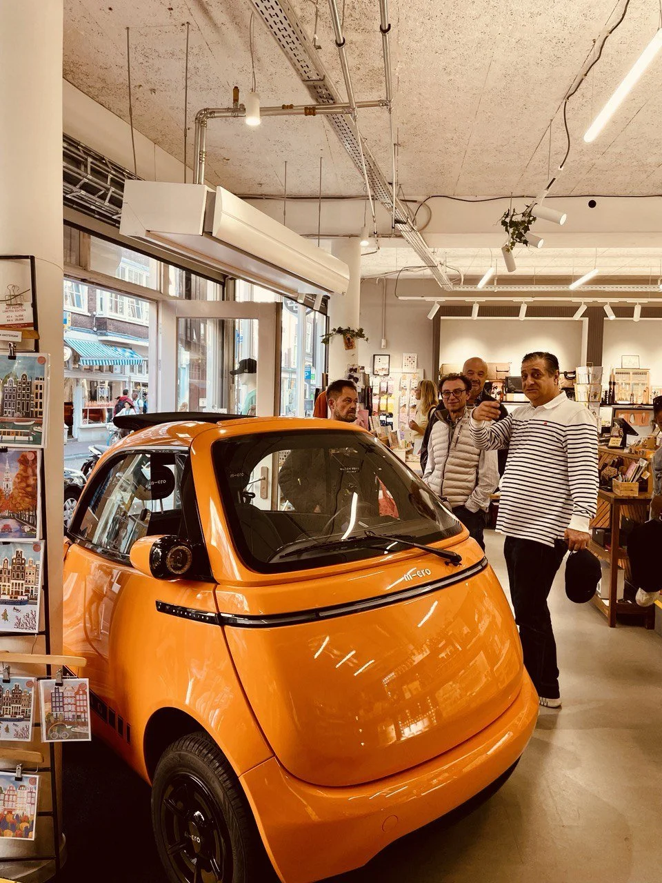 Pop-up store with orange micro-car display in Amsterdam — Nata Buro retail activation project