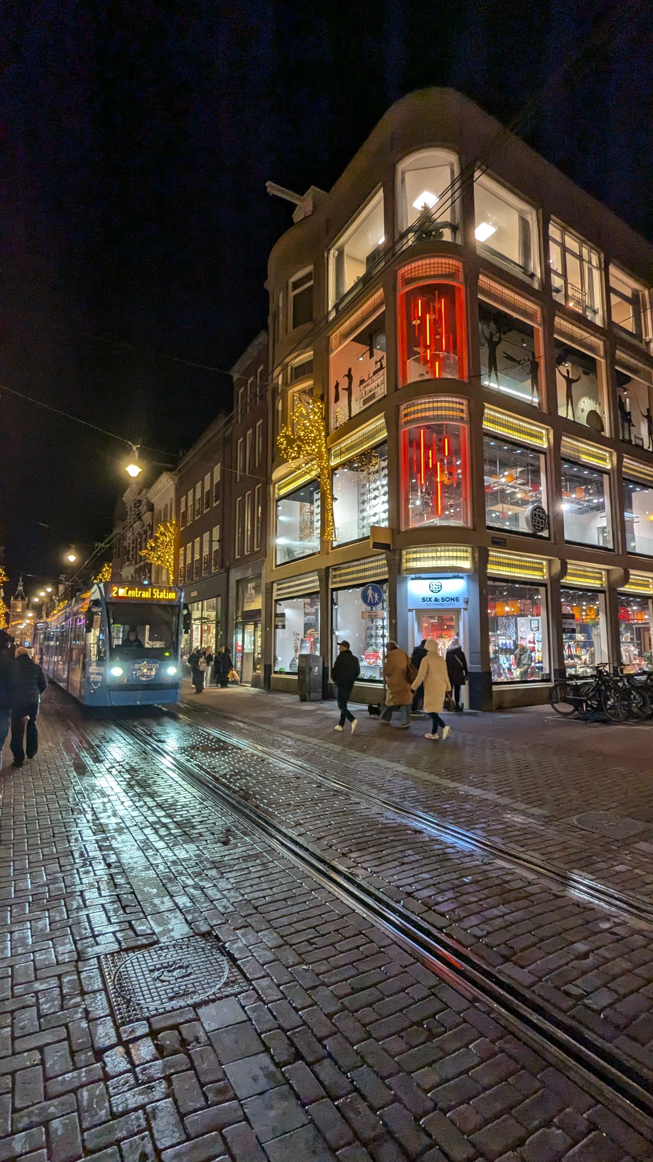 Amsterdam street at night — vibrant retail scene with illuminated storefronts and creative pop-up locations curated by Nata Buro