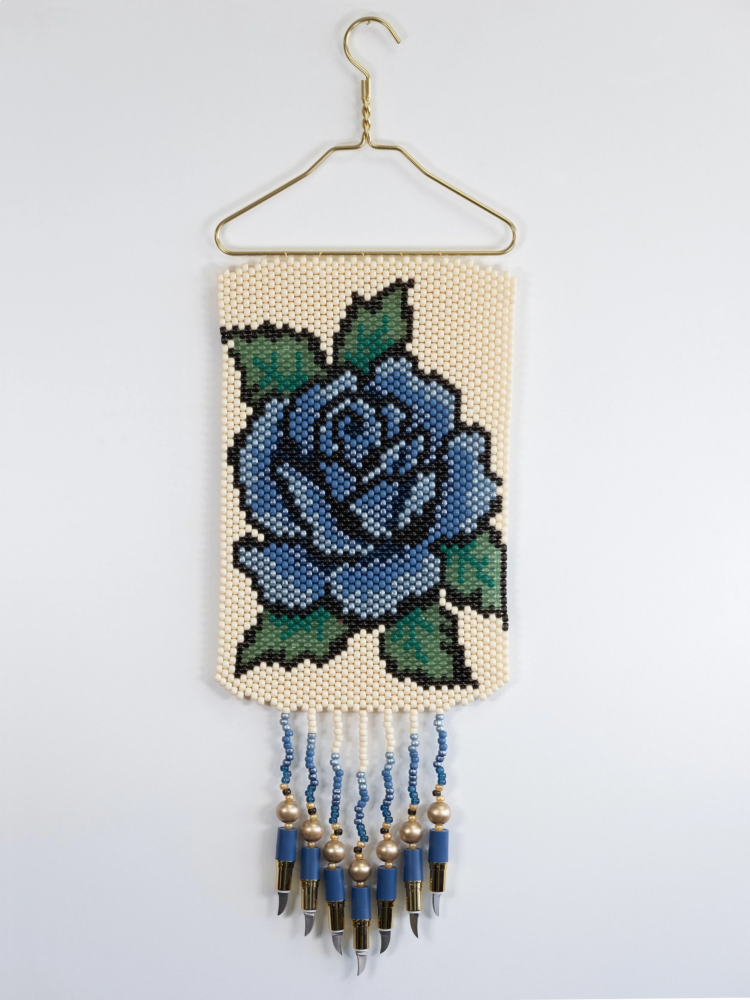 Deer Woman (blue),
Metal hanger, plastic and wood beads, lipstick knives, 12" x 36"