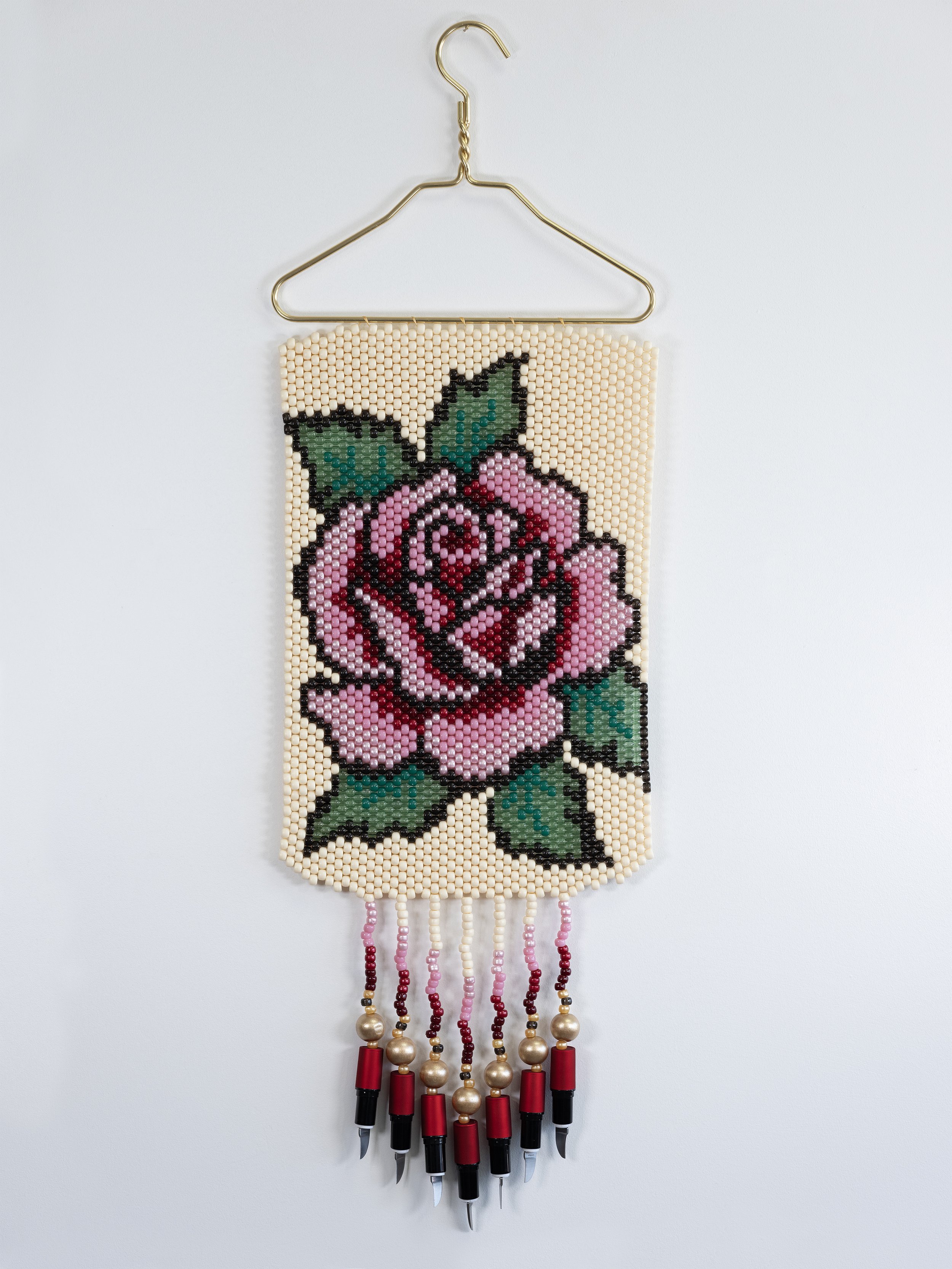 Deer Woman (pink),
Metal hanger, plastic and wood beads, lipstick knives, 12" x 36"