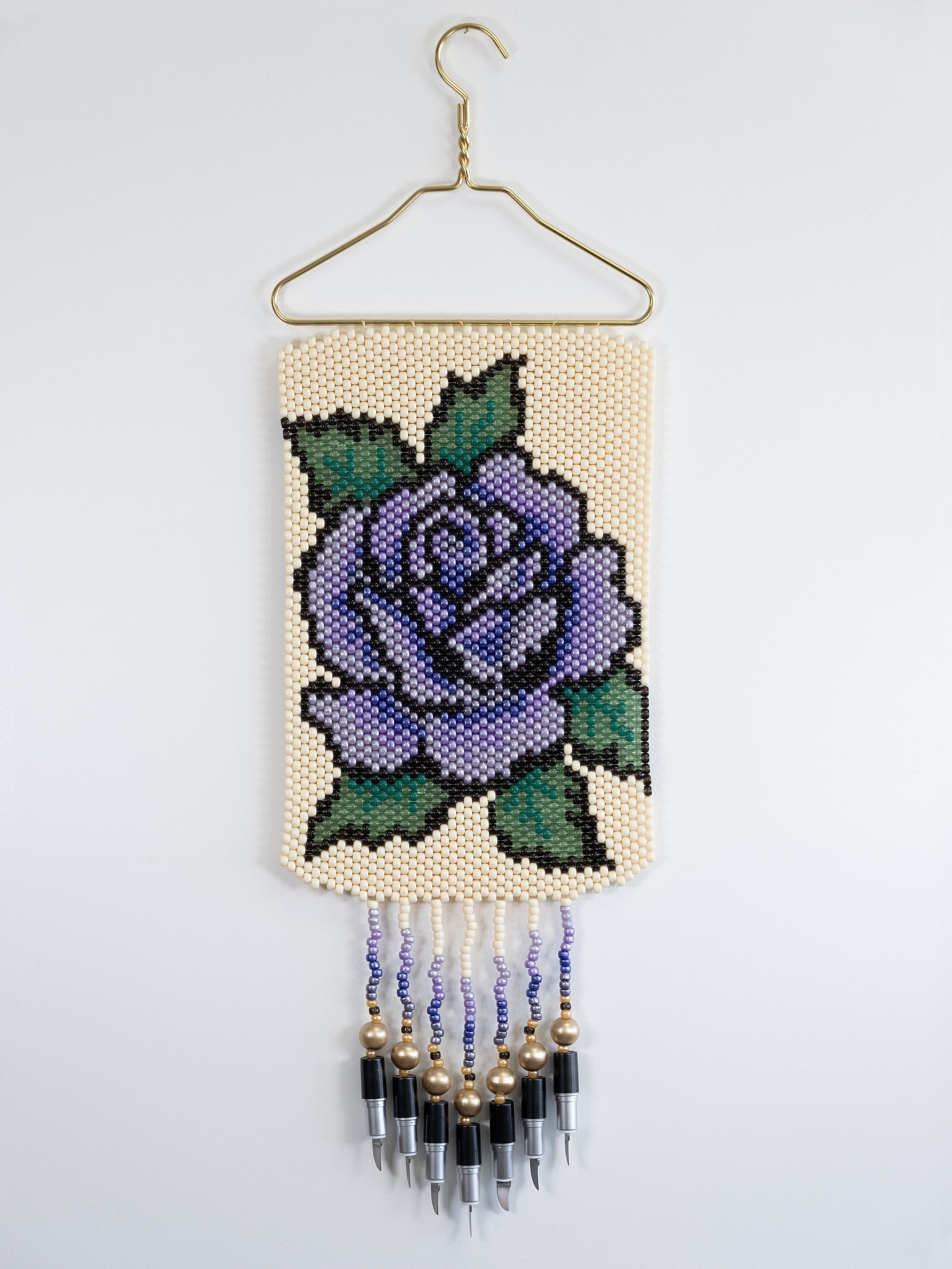 Deer Woman (purple),
Metal hanger, plastic and wood beads, lipstick knives, 12" x 36"