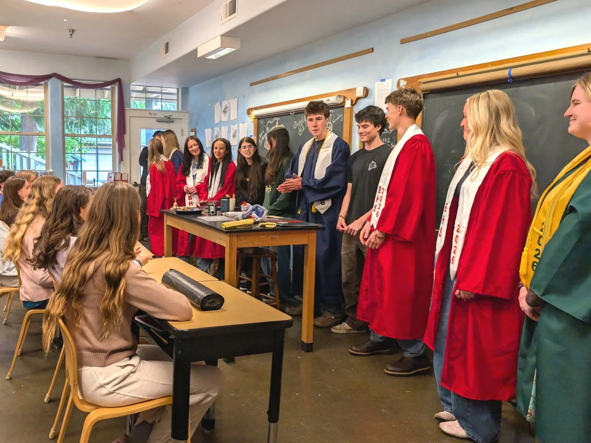 Graduates in robes in classroom