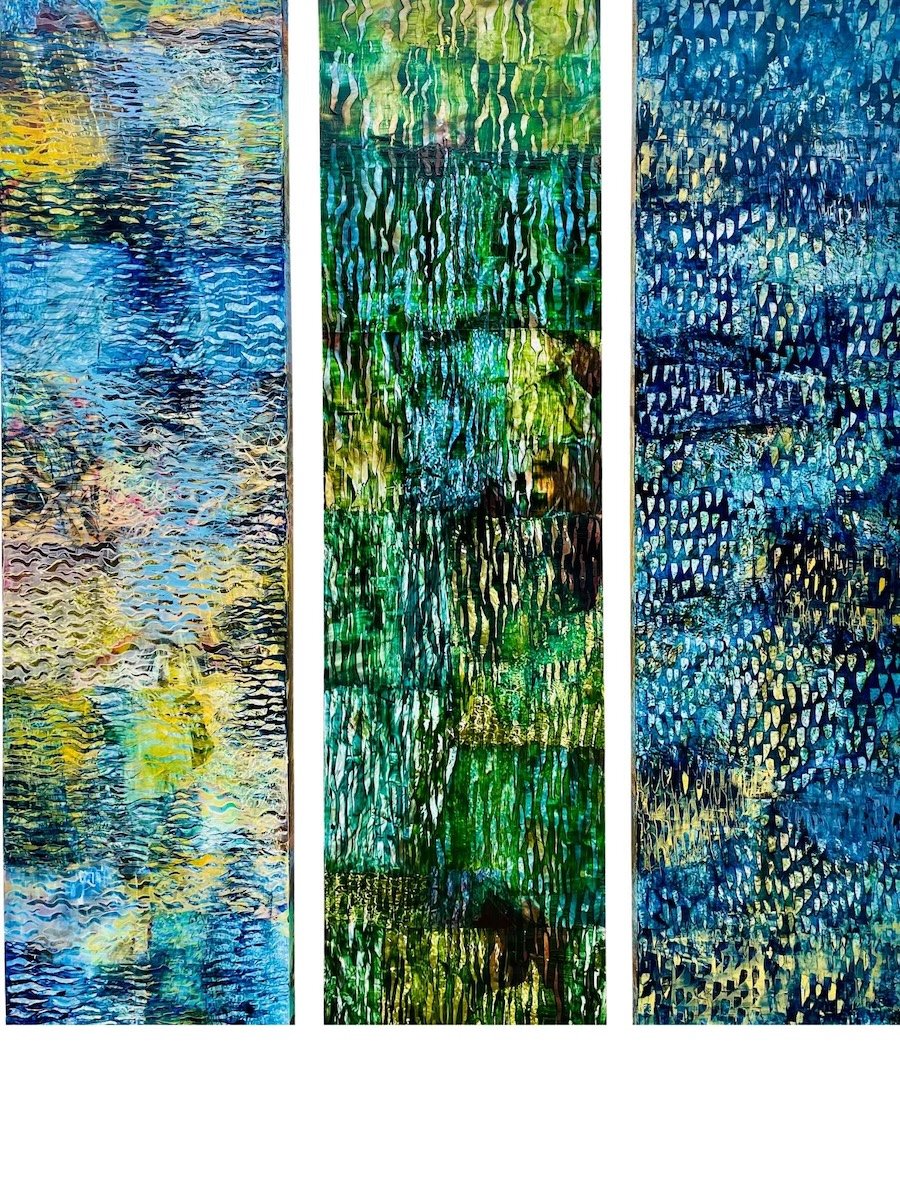 Three vertical abstract paintings with textured, geometric patterns in shades of blue, green, and yellow.