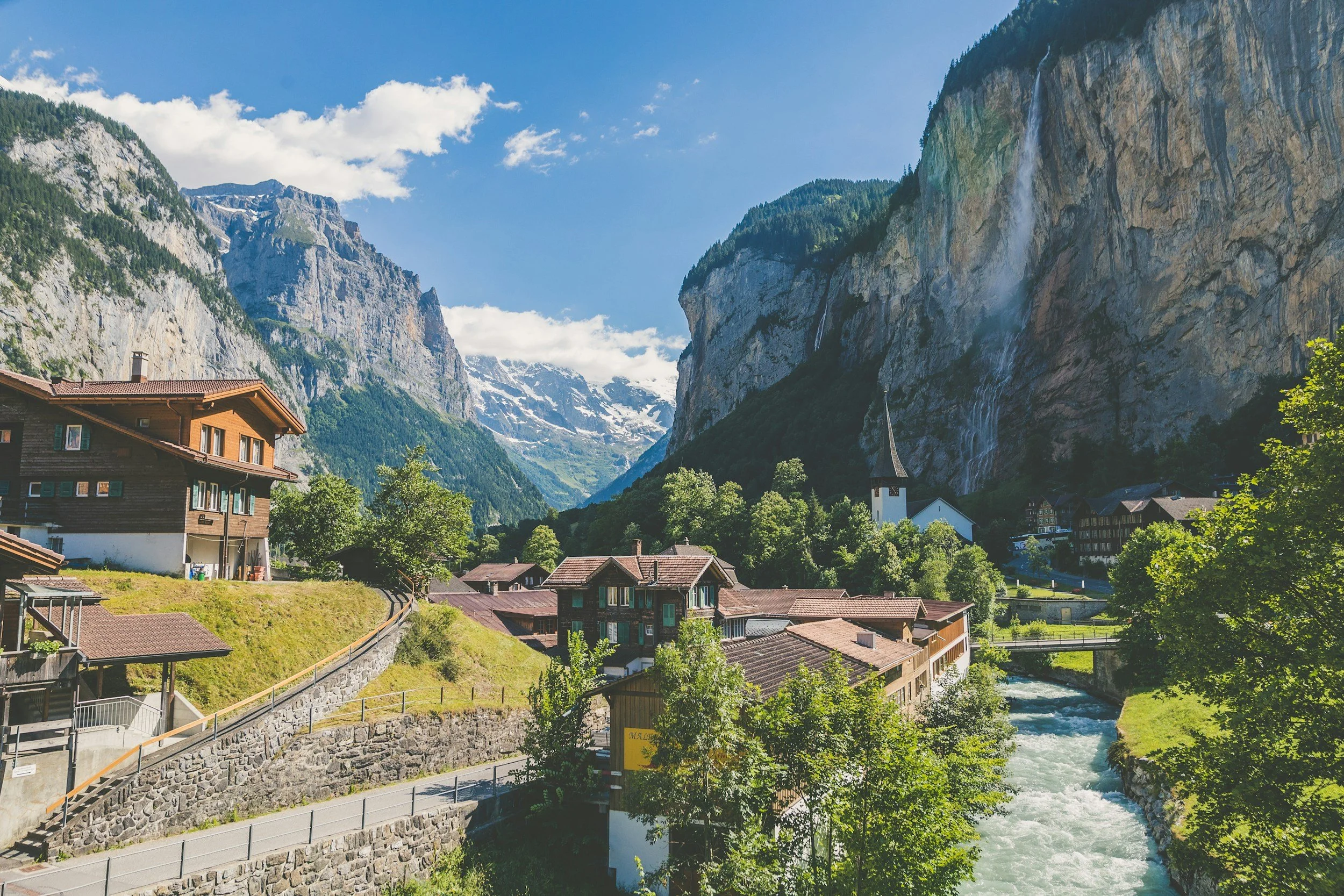 switzerland valley waterfall lauterbrunnen falls river mountain cliffs with church in foreground 
