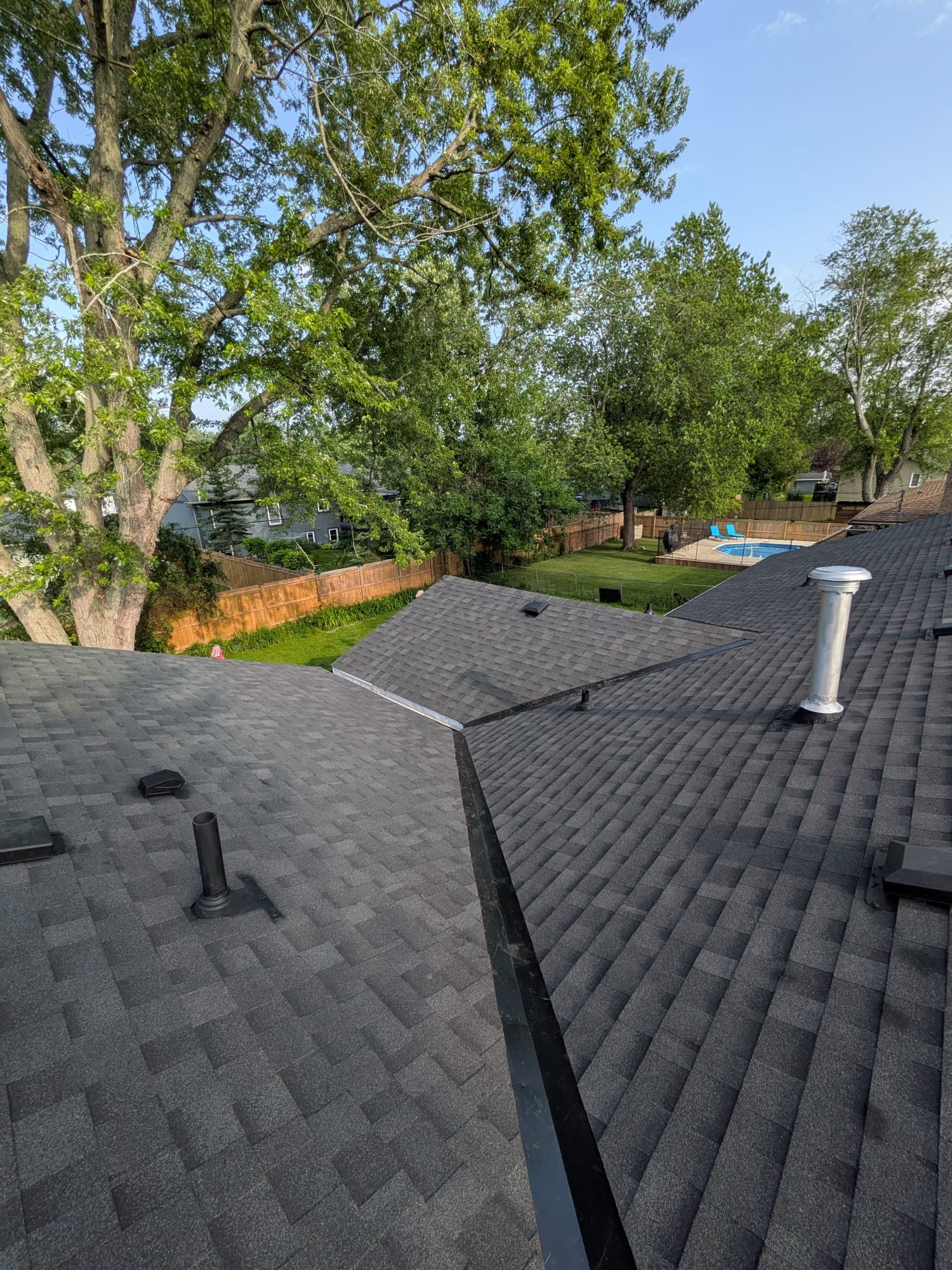 Full roof replacement above a fenced backyard and pool in St. Catharines