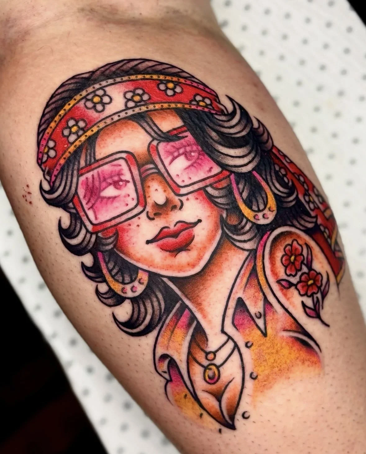 Colour Trad tattoo of a 70s lady face with glasses by Brandy G