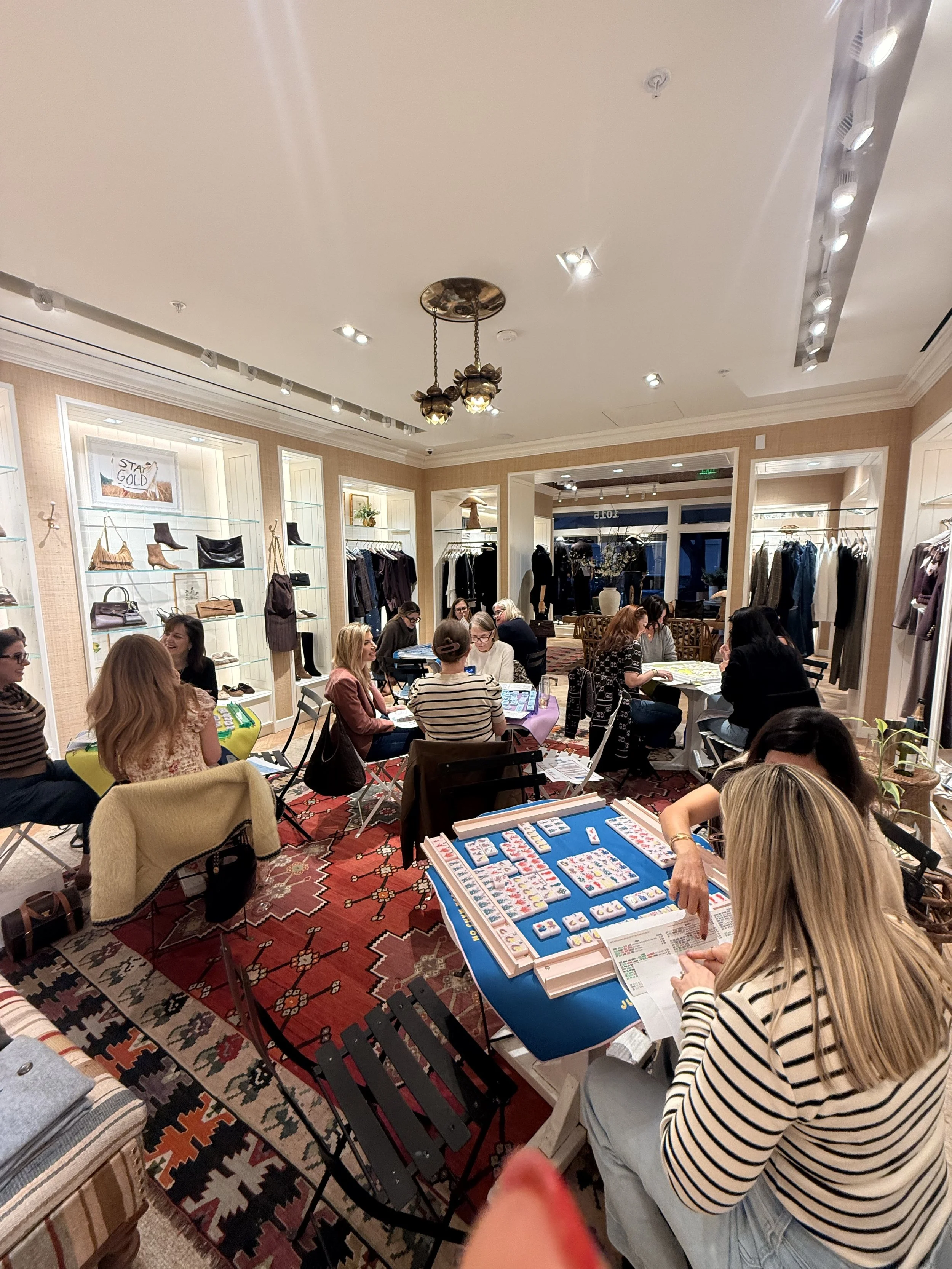 People playing Mahjong at tables.