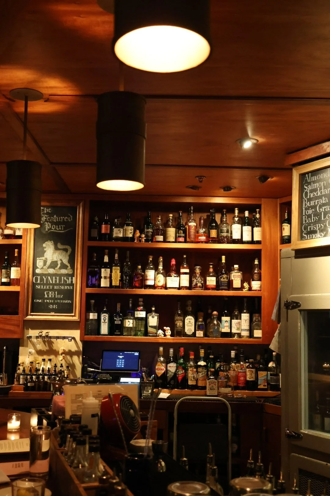 The backbar at Tavern Law, a craft cocktail bar on Capitol Hill in Seattle, lined with whiskey bottles.