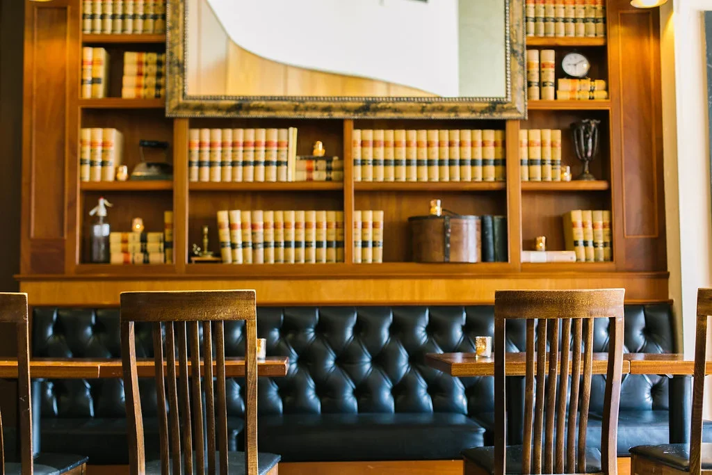 The candlelit main bar and leather banquettes at Tavern Law, Capitol Hill Seattle.