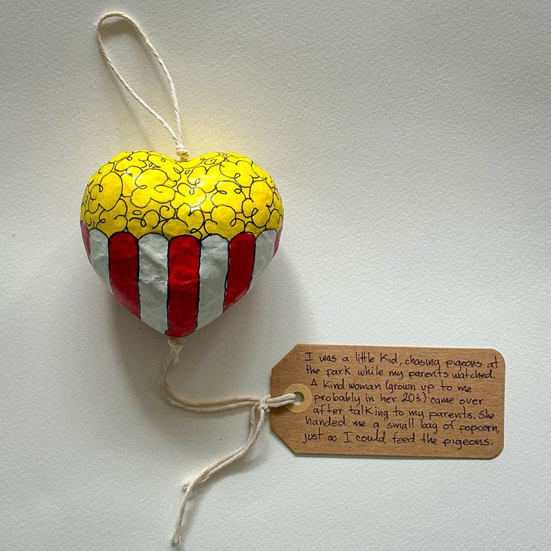 A cardboard heart shaped kindbloom decorated with popcorn