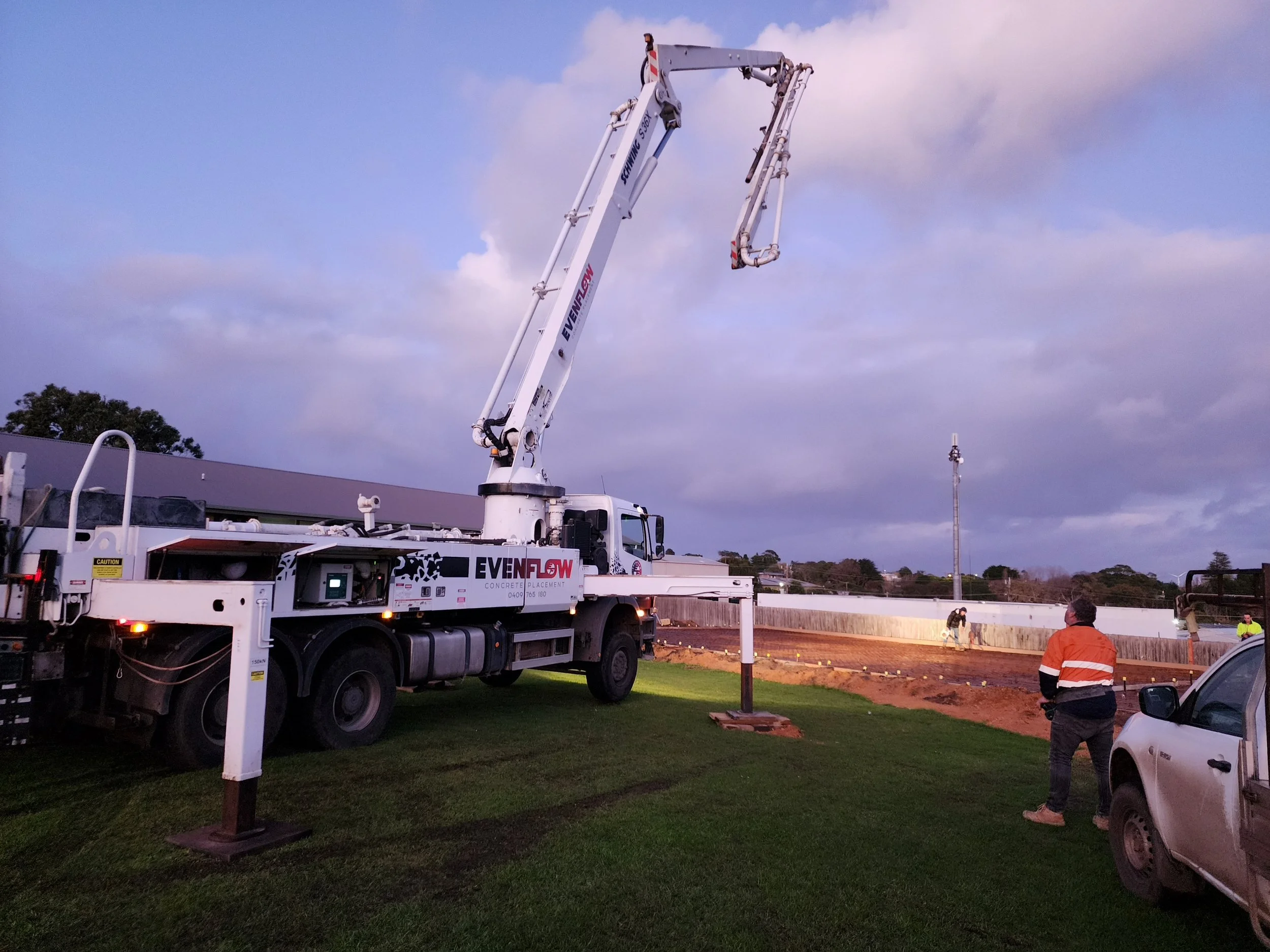 Construction site for shed with a large concrete pump truck 