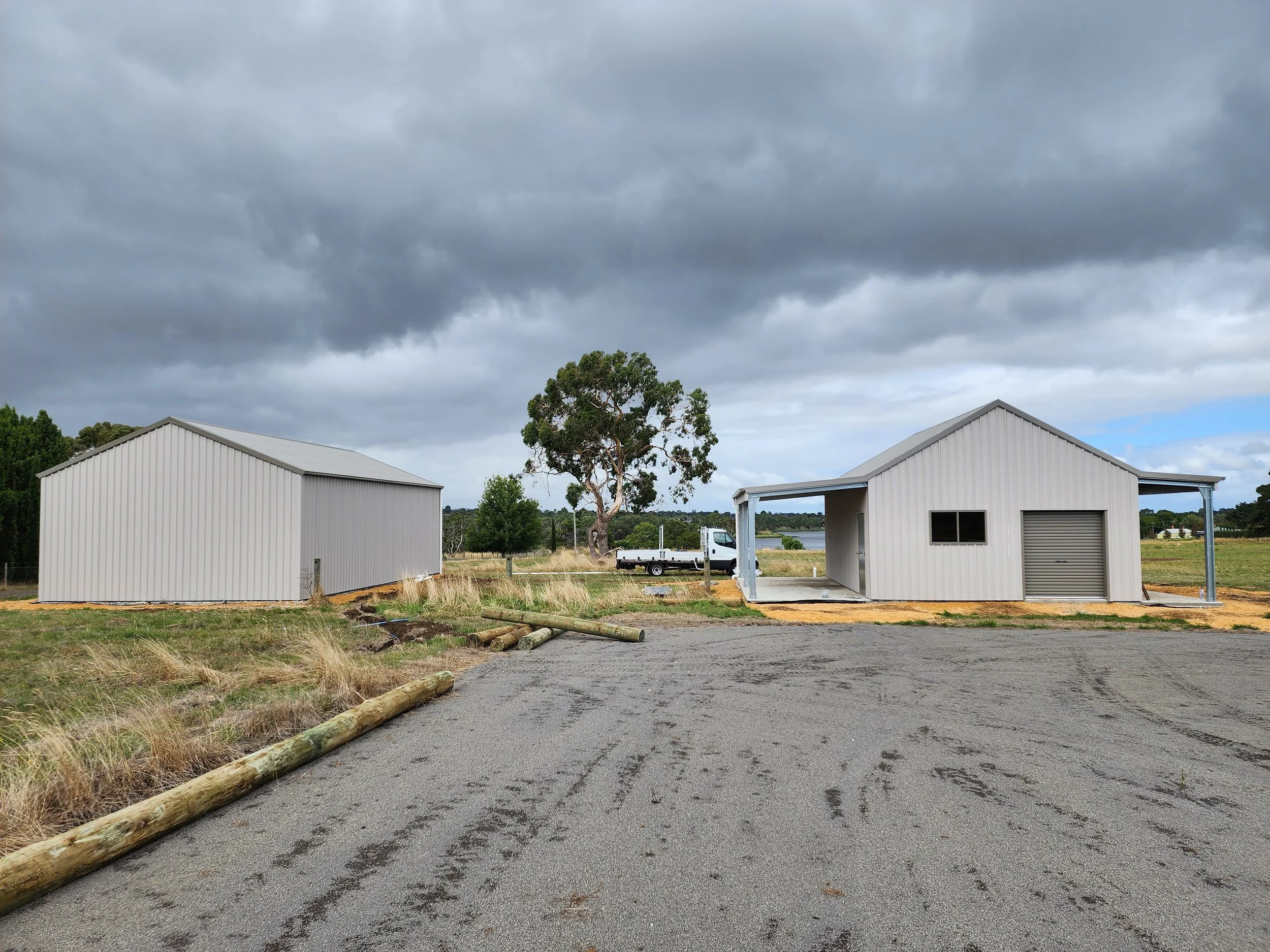 Two metal custom sheds built by M&C Sheds