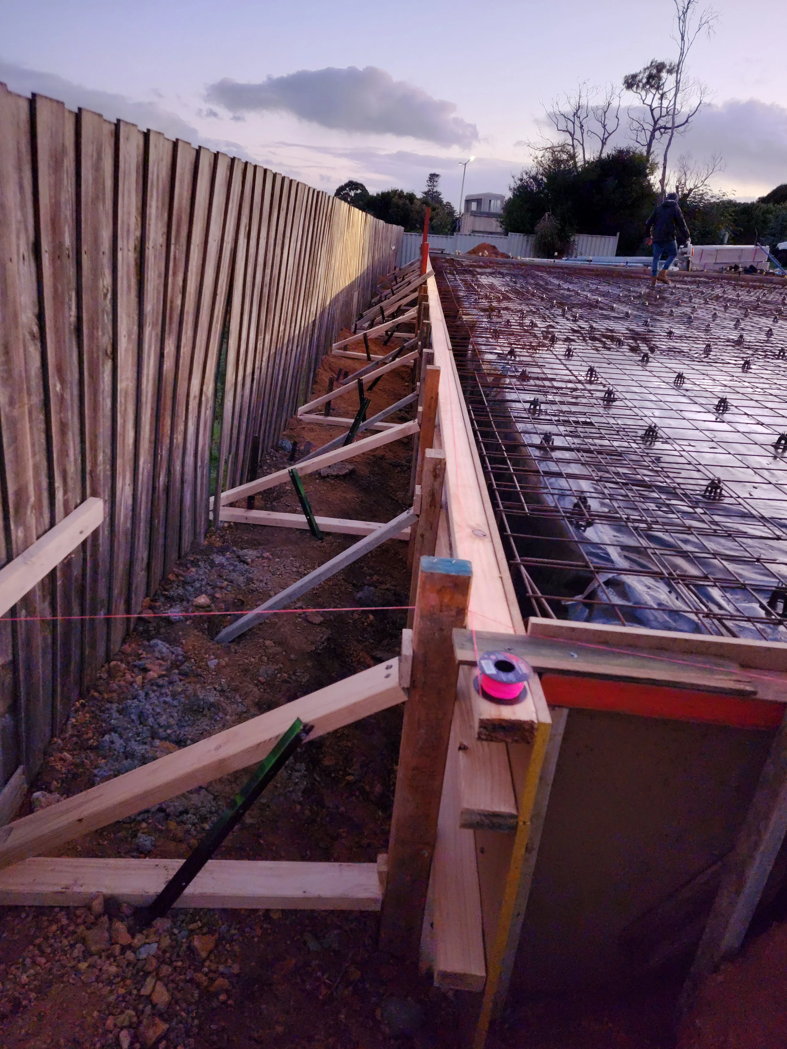 Construction site shed with a wooden frame and metal reinforcement on a building foundation