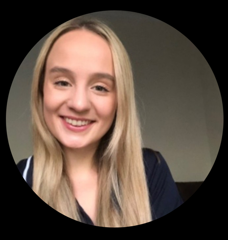Portrait of a smiling young woman with long blonde hair wearing a dark top.