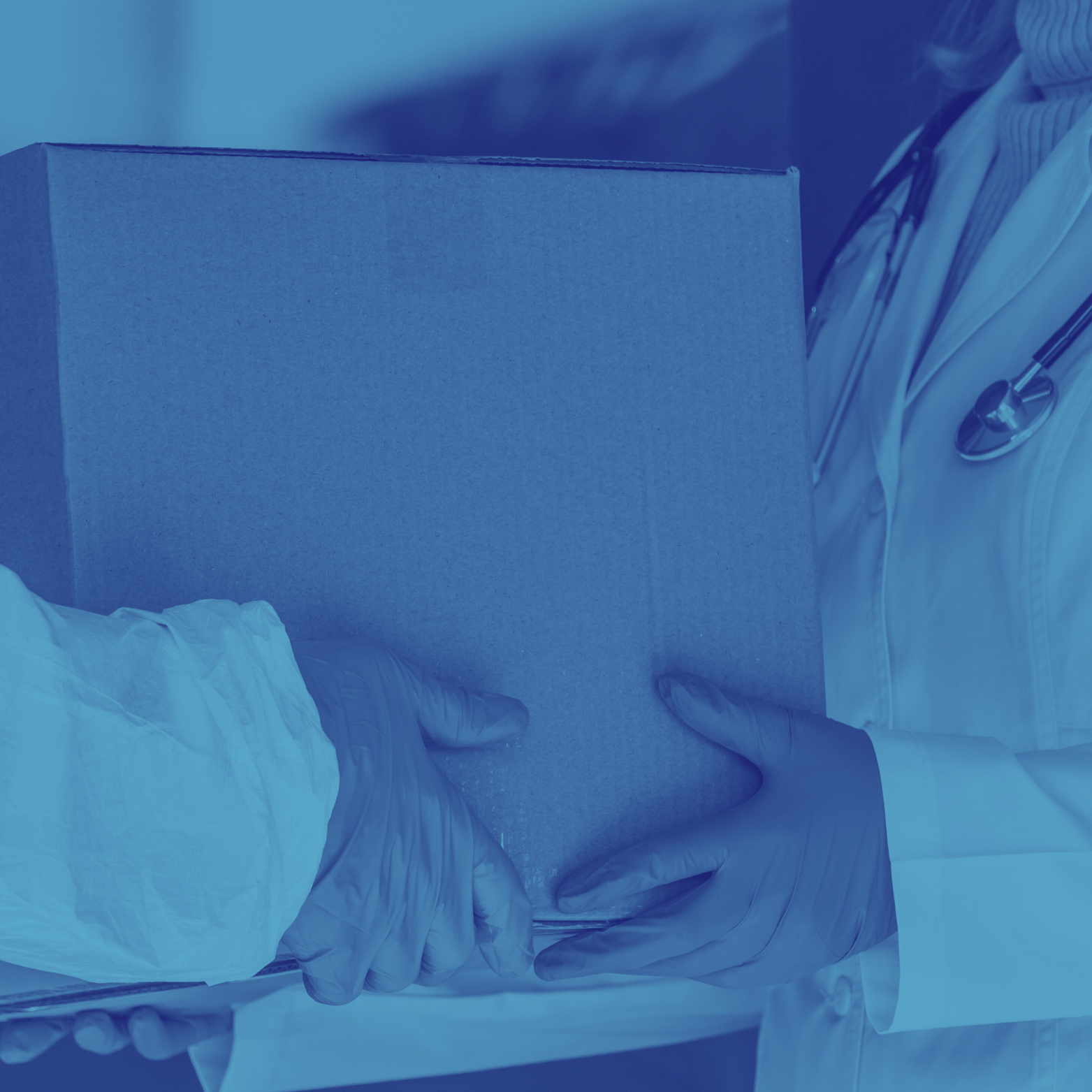 A healthcare worker wearing gloves and a white coat holding a cardboard box, with a stethoscope around their neck.