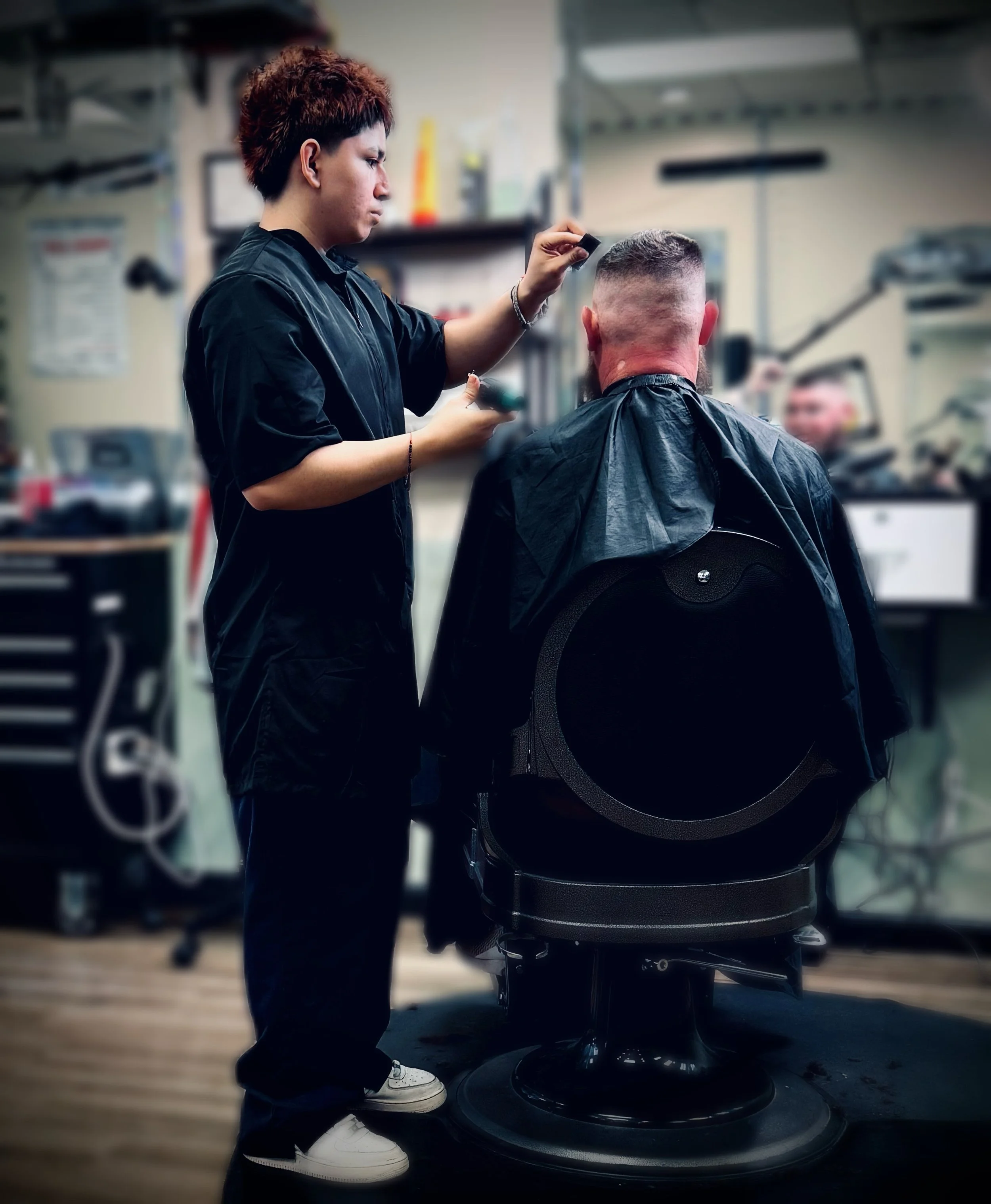 Barber giving a haircut to a customer in a barber shop