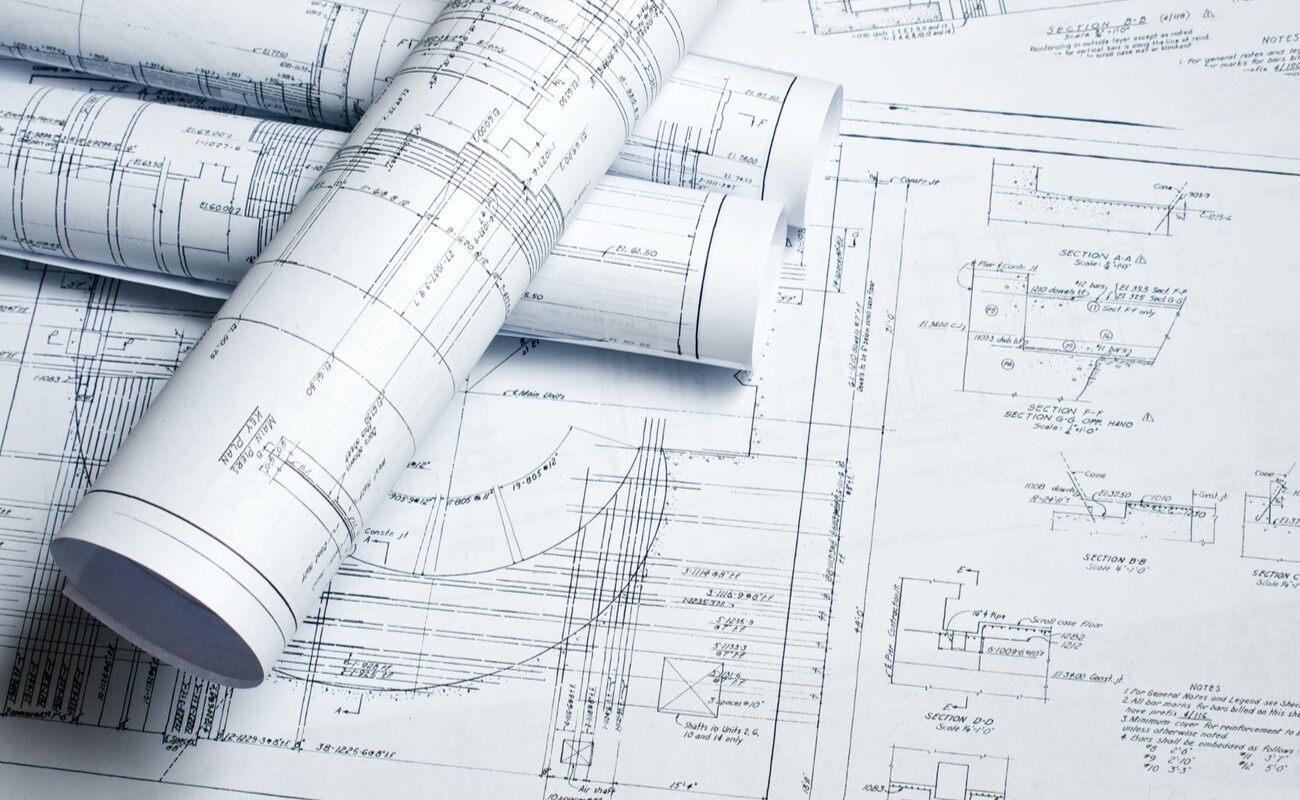 Blueprints or technical drawings spread out on a surface.