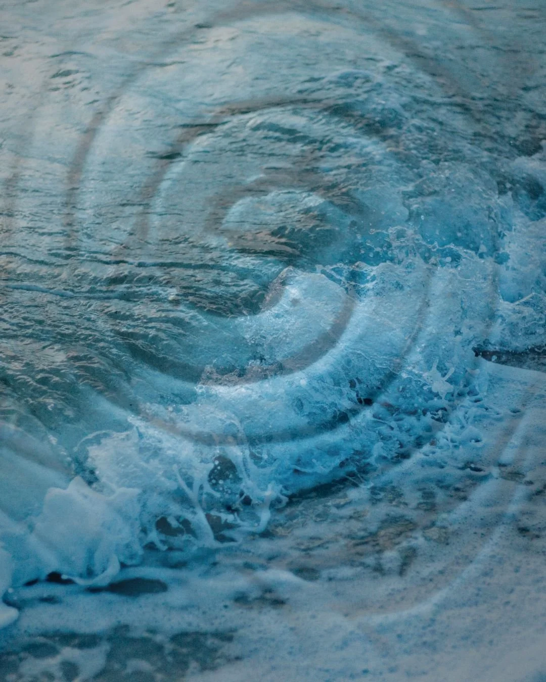 Close-up of turbulent ocean waves with white foam and crashing water.
