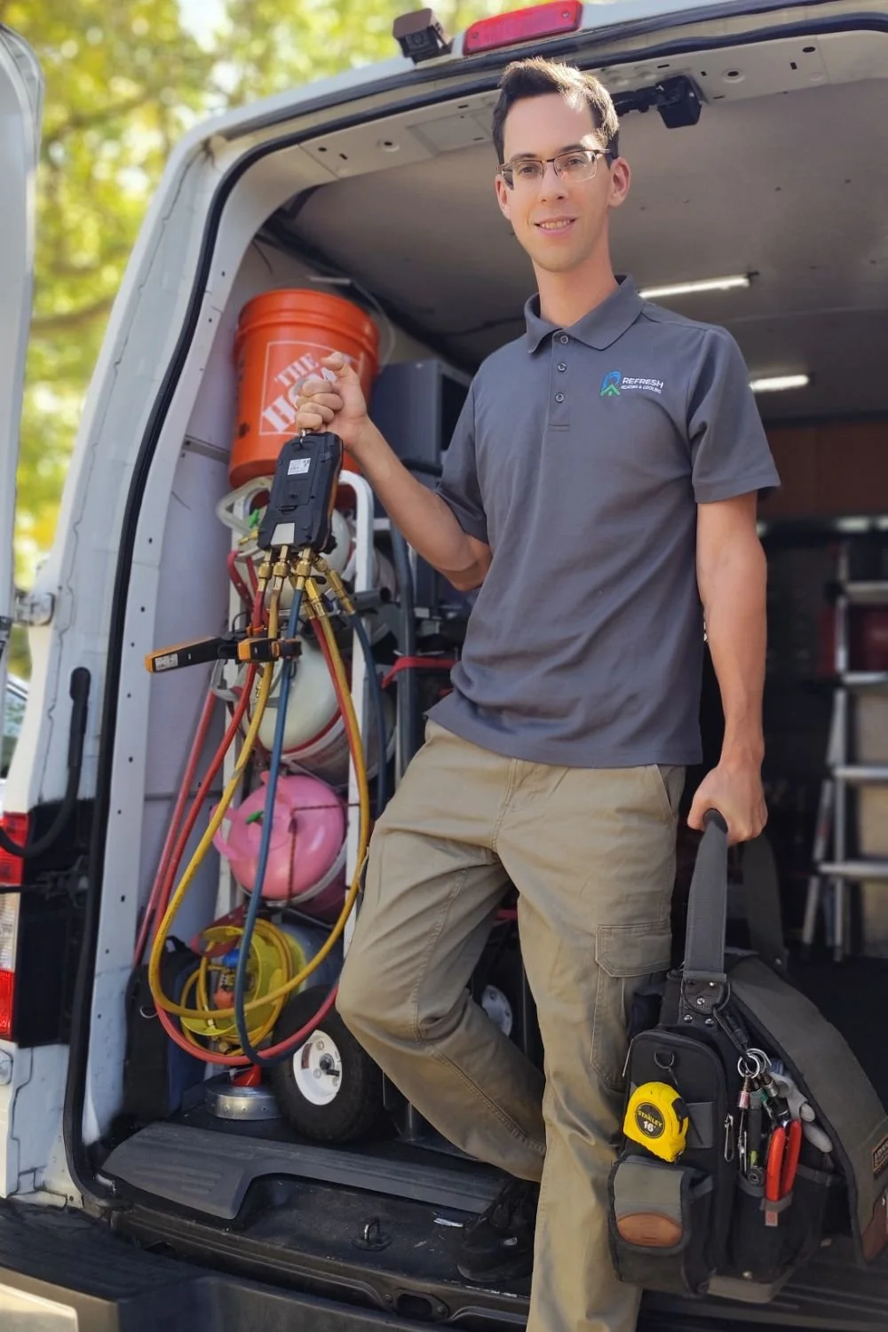 Refresh Heating & Cooling technician standing beside his service van with HVAC diagnostic equipment, ready to help Sacramento homeowners with heating and air conditioning repairs.