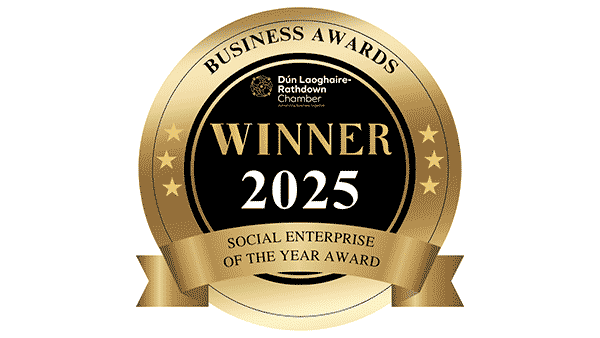 Gold circular award badge with black center, gold border, and ribbon. Text reads 'Business Awards,' 'Dún Laoghaire-Rathdown Chamber,' 'Winner 2025,' and 'Social Enterprise of the Year Award.'