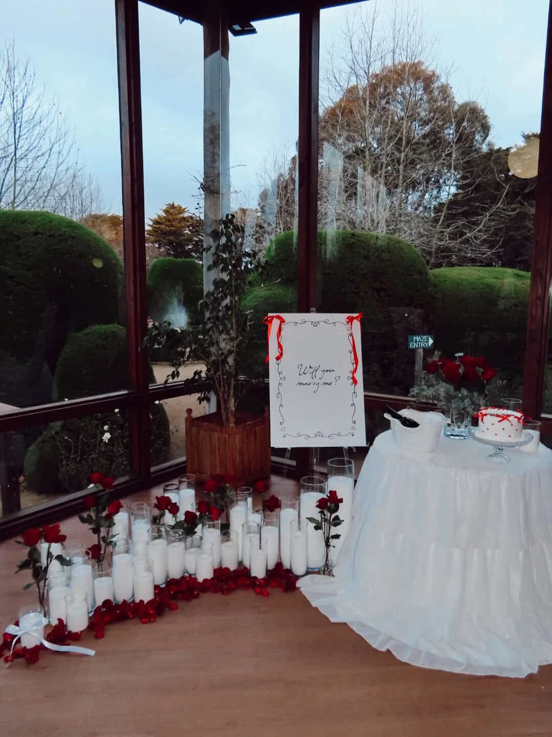 Opulent luxury proposal setup in Melbourne planned for a private engagement experience amongst a sea of candles and roses