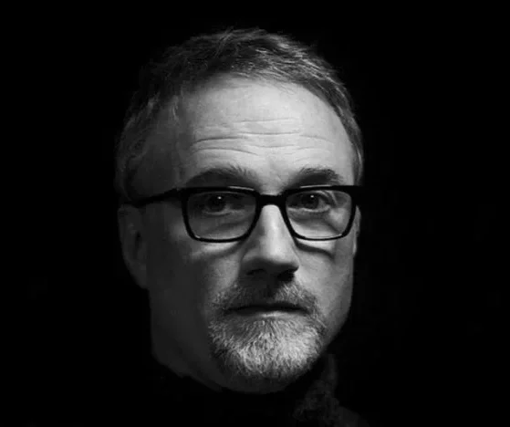 Black and white portrait of a middle-aged David Fincher man with glasses, short hair, and a beard.