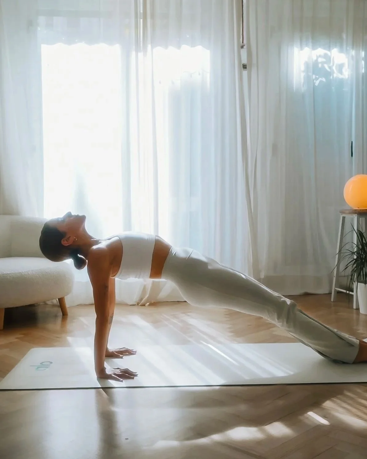 Woman doing reverse plank pose at home yoga practice for strength and flexibility