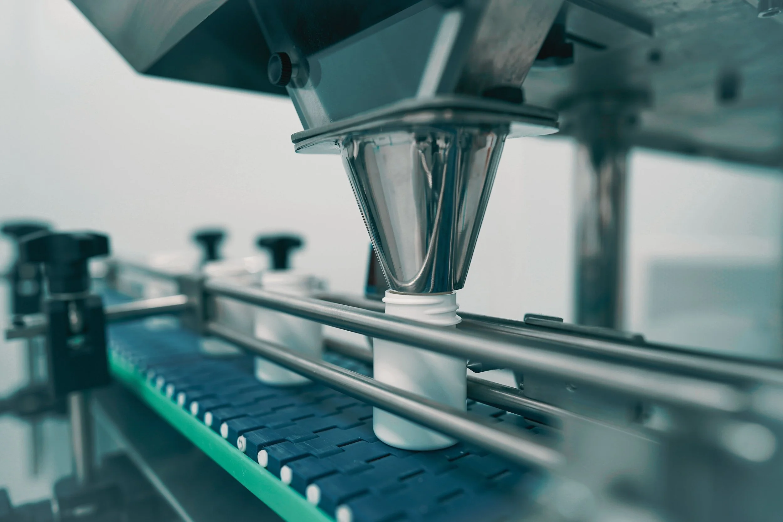 Machine filling bottle with supplements.jpg