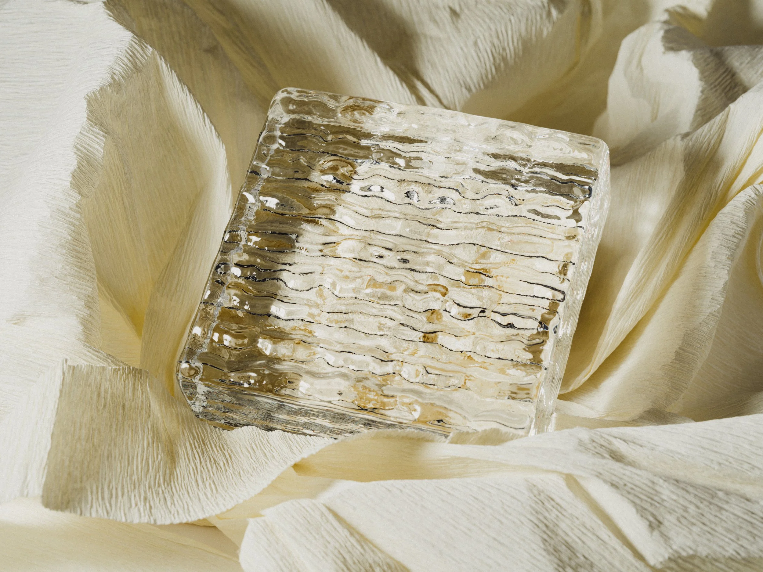 Solid square glass block with rippled texture 