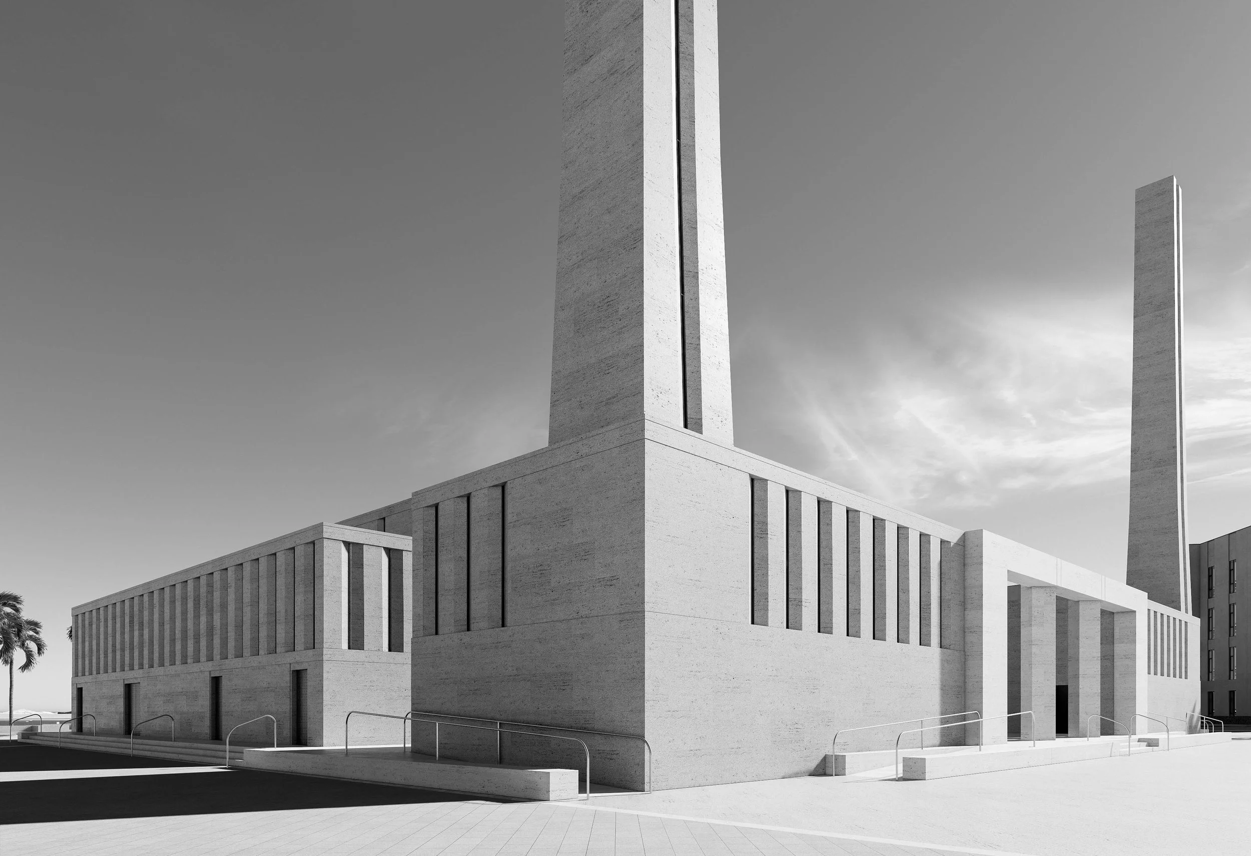 Edificio con paredes de piedra y dos torres altas, en un entorno despejado, en blanco y negro.