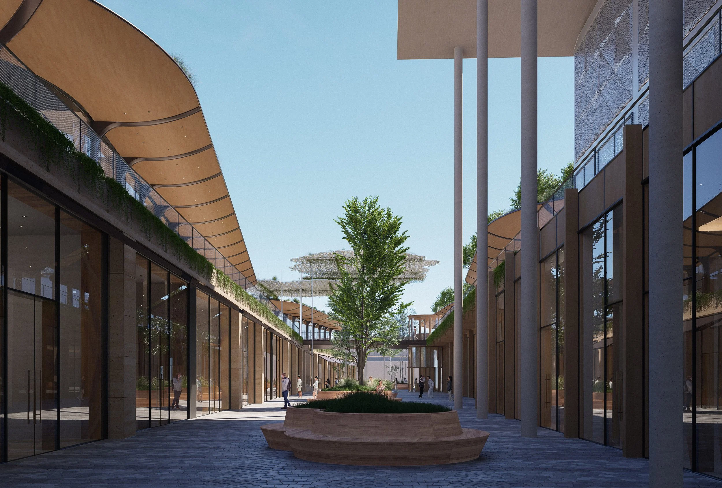 Un patio moderno con edificios de dos pisos, grandes ventanas de vidrio, columnas y un árbol en el centro, bajo un cielo despejado.