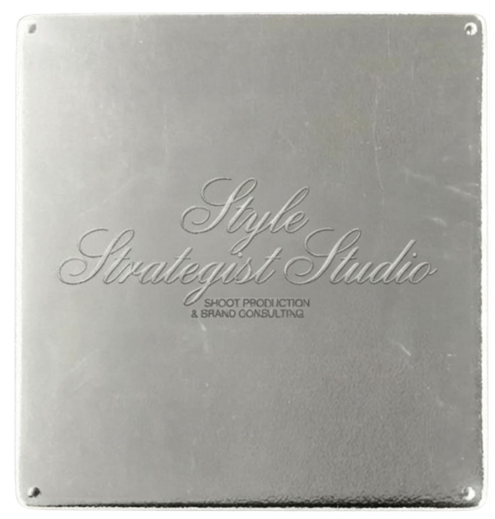 A silver square metal sign with engraved text that reads 'Style Strategist Studio' and 'Shoot Production & Brand Consulting'.