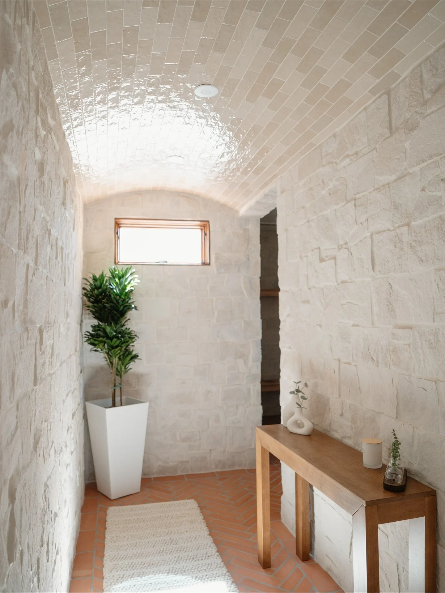 I am happy to finally share this en suite spa that was designed to feel like a luxurious desert getaway &mdash; without ever leaving home.

Saltillo floors, stone-wrapped walls, and a tiled barrel ceiling lead to a serene steam shower and cedar sauna