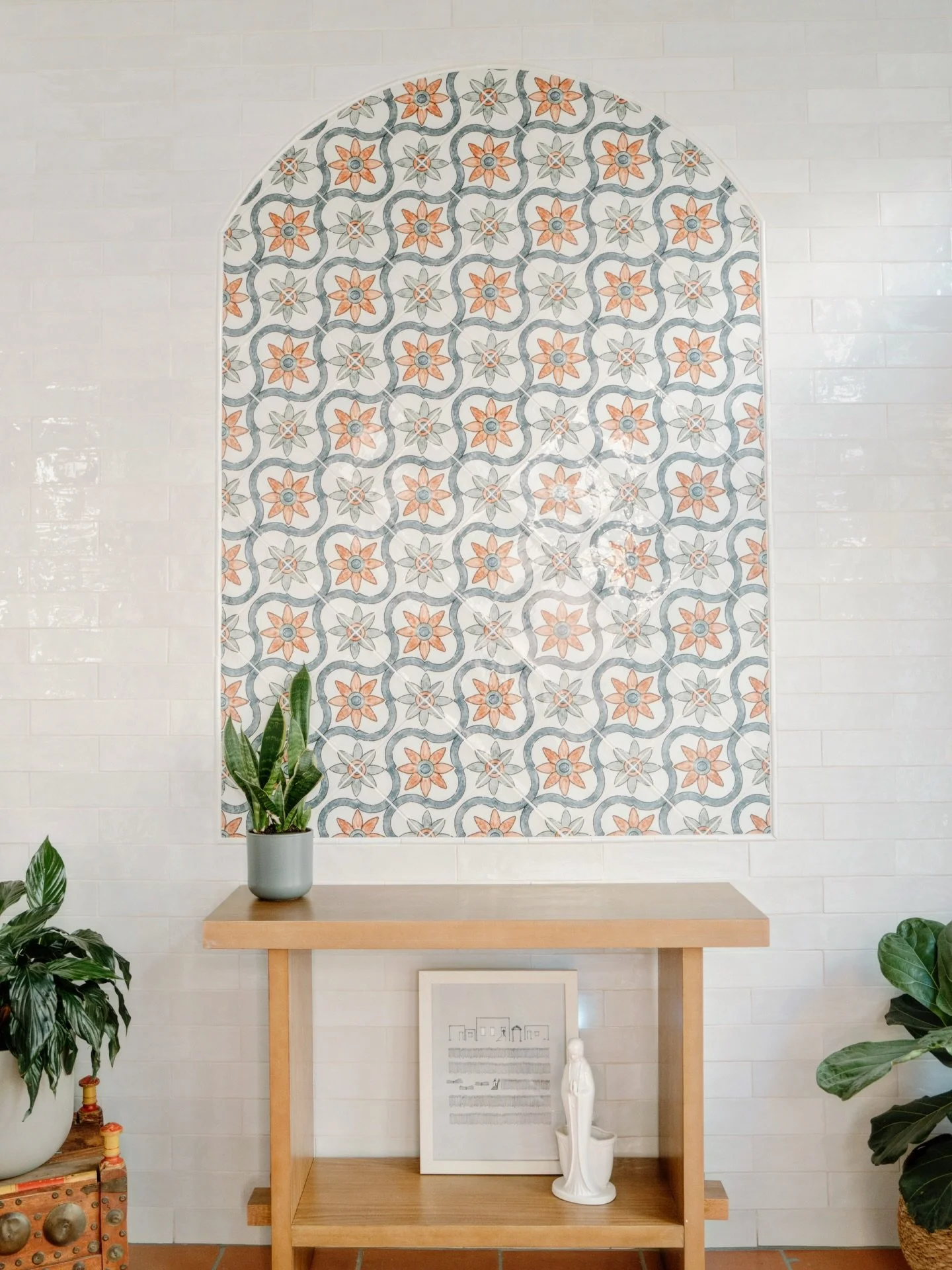 Nestled off the primary bedroom, this sunroom is a sun-drenched escape. Featuring terracotta tile floors, a textured wood plank ceiling, and a striking tiled feature wall that adds color and pattern to brighten up any part of the day! This tile wall 