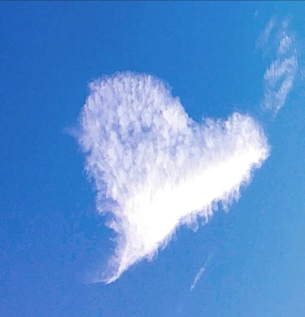 Cloud shaped like a heart in the blue sky.