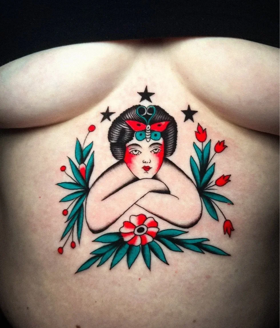 Tattoo of a geisha with flowers and foliage, featuring a butterfly hair ornament and three black stars above her head.