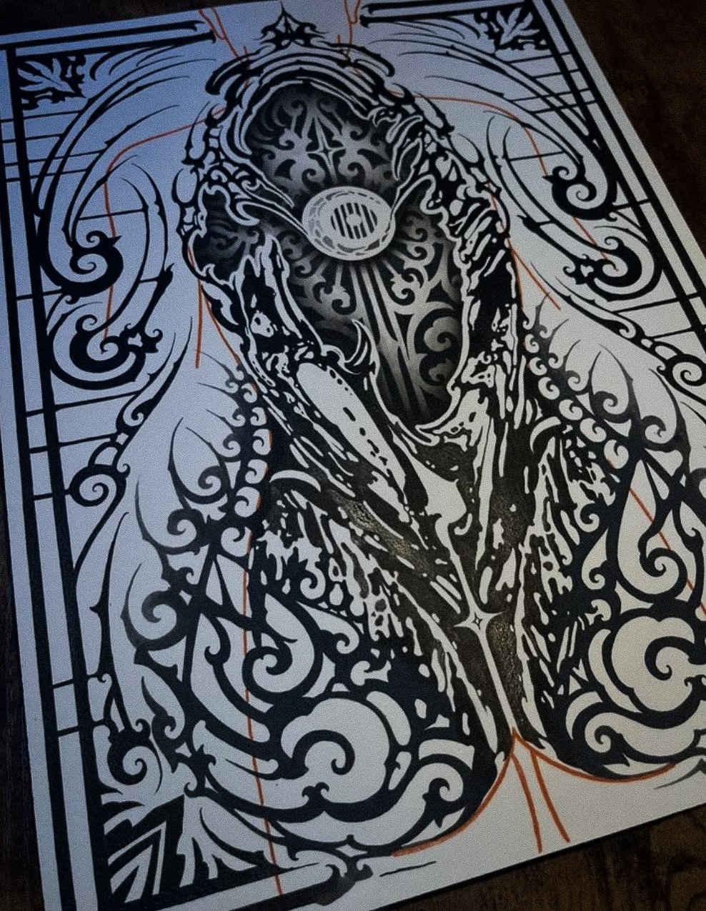 A black and white intricate line drawing of a woman with flowing hair, surrounded by ornate decorative patterns and swirls.