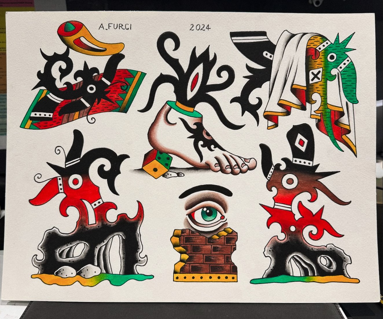 Colorful tattoo-style artwork featuring a human foot, an eye, a mountain cave scene, and various abstract and decorative elements in black, red, green, and yellow.