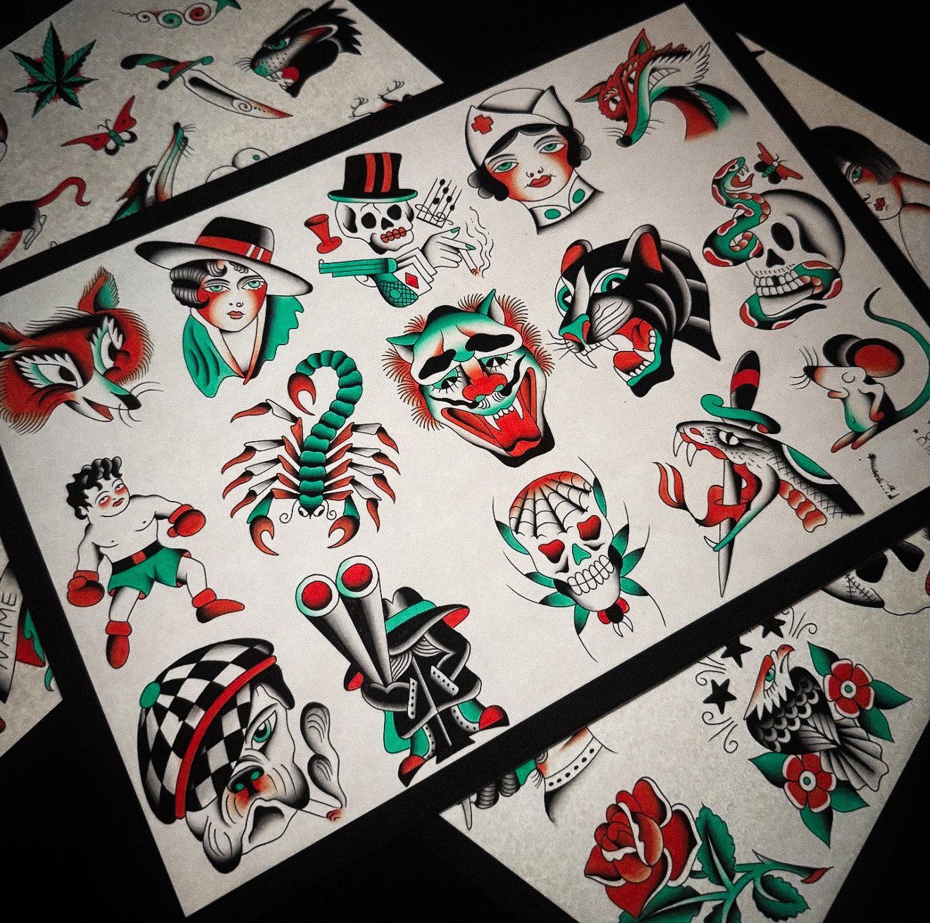 Traditional American tattoos featuring skulls, a scorpion, tigers, dragons, a woman, a man with a hat, a skeleton with a gun, a rabbit, a rose, and other classic tattoo images in black, red, green, and white colors.