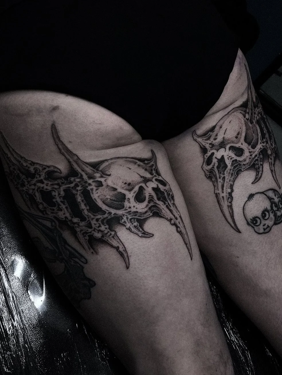 Tattooed skulls with horns on upper arms