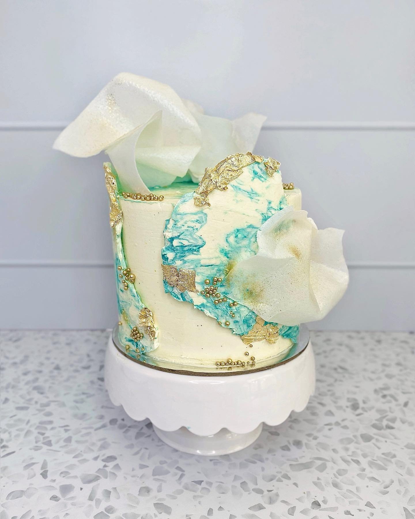 The 5&rdquo; cutting cake that went along with the 80 blue, teal, white and gold cupcakes ✨

A few different techniques in here, with the marble buttercream wrap and wafer paper sails, topped off with gold and glitter ✨ 

Anyone who knows me, knows I
