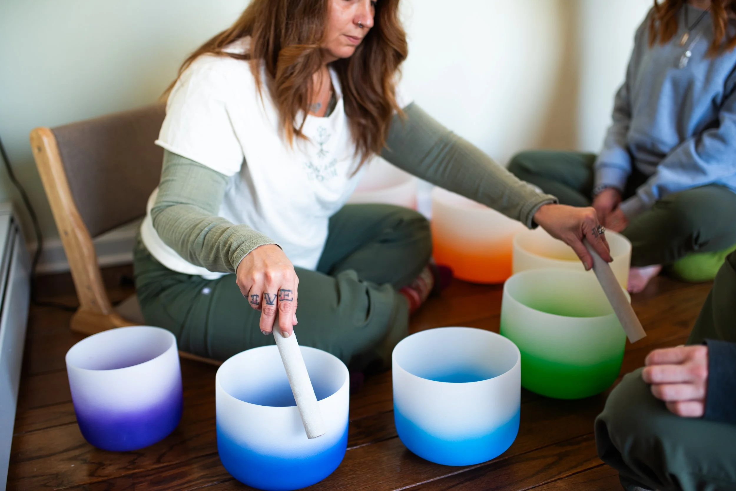 Tamra McGovern playing sound bowls for mental health and substance use facilities. 