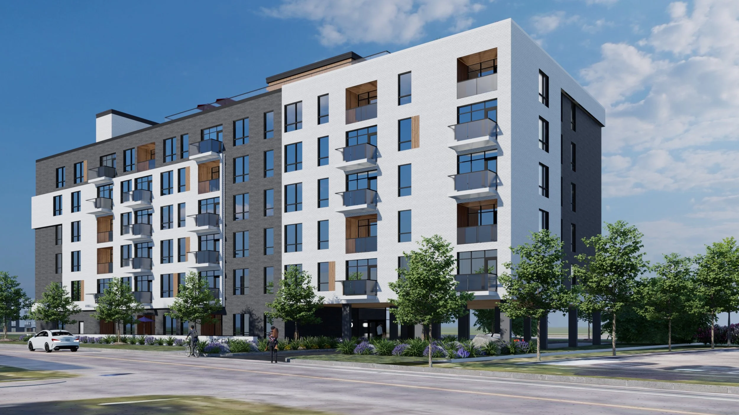 Vue d'un immeuble résidentiel moderne avec plusieurs étages, balcons en verre, et des arbres en premier plan.