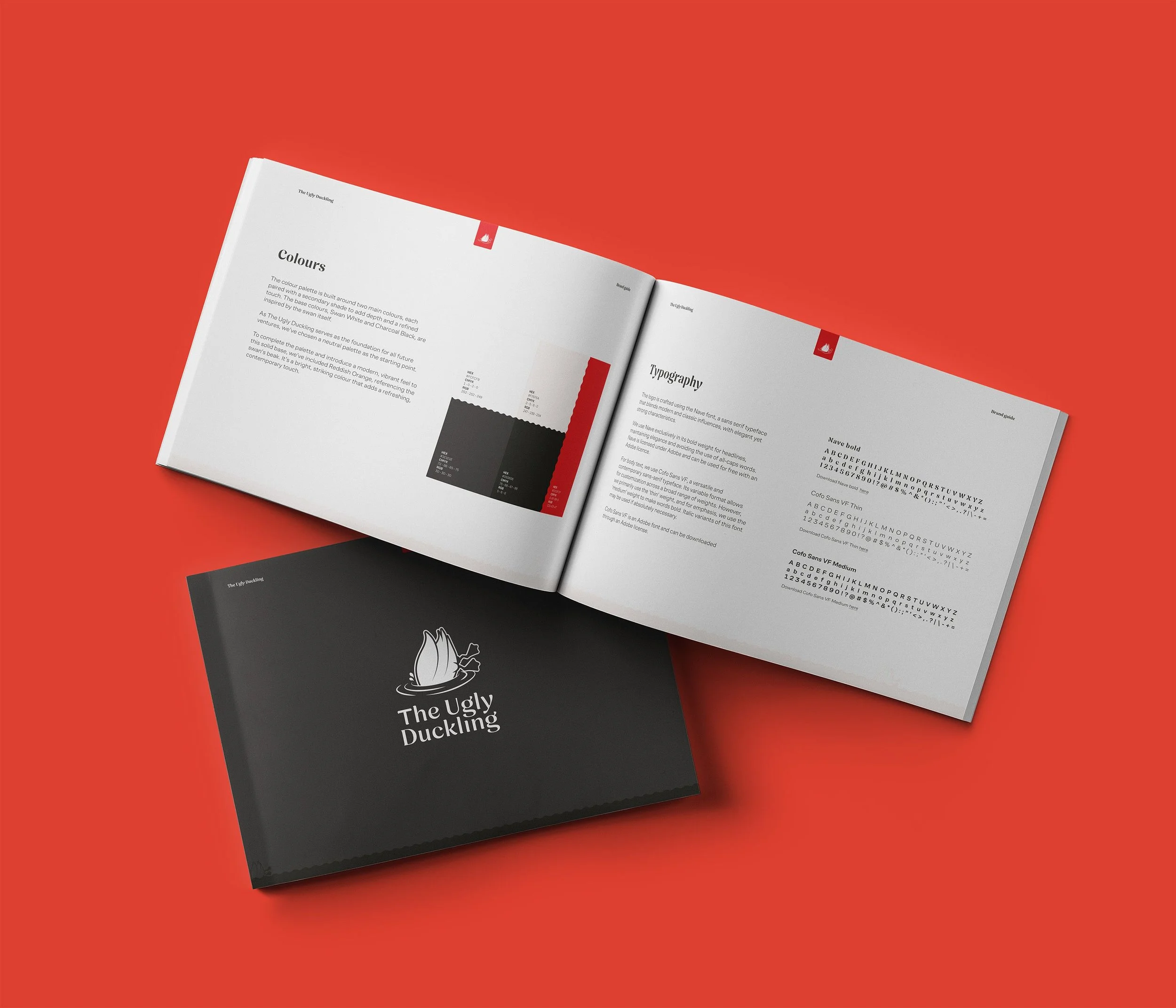 Open book displaying typography and color design guidelines, with a black folder labeled 'The Ugly Duckling' positioned on a red background.