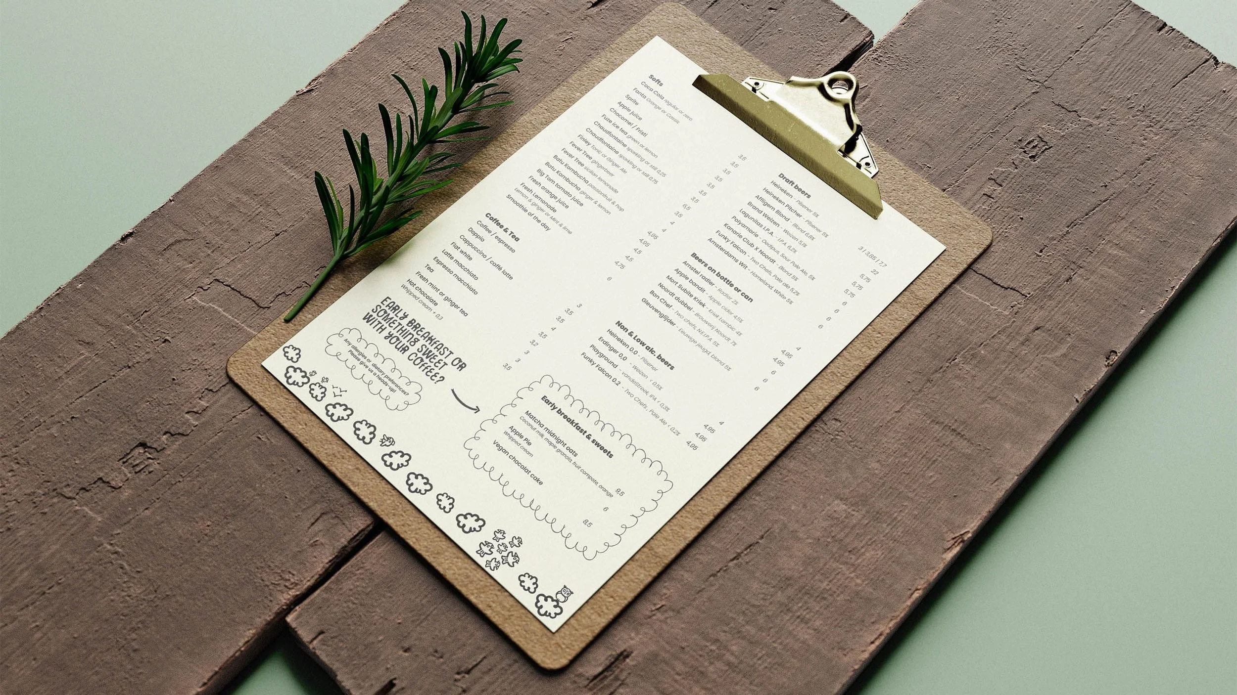 Menu on a clipboard with a sprig of rosemary on a wooden surface.