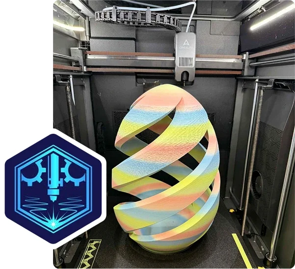 A colorful 3D-printed spiral sculpture inside a 3D printer enclosure, with the printer's extruder and frame visible.
