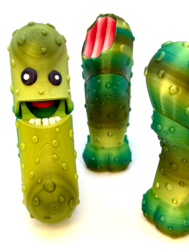 Three colorful plastic toys shaped like caterpillars with smiling faces and textured bodies.