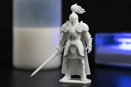 White miniature warrior figurine with armor, helmet with feather, and sword, 3D printed (SLA) with Standard resin.