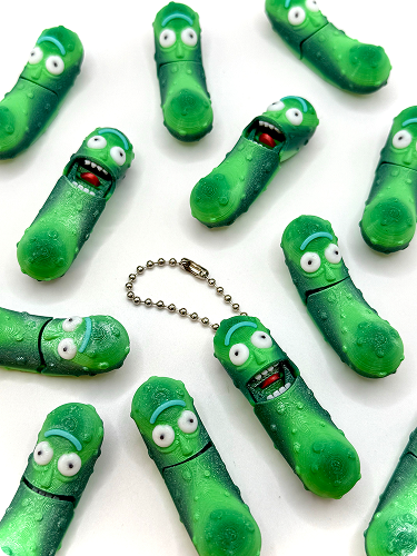 Multiple green pez dispensers with cartoonish faces, scattered on a white surface.