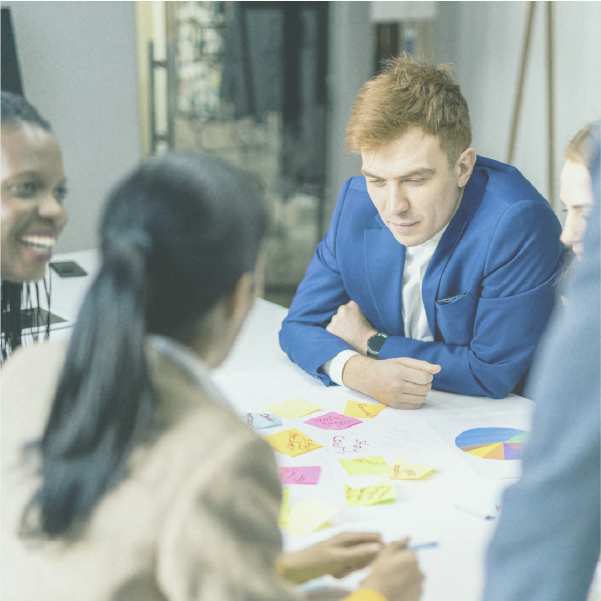 Business team meeting with colorful sticky notes and charts on the table.